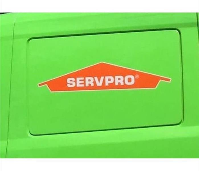 An outline of an orange house with the word SERVPRO in the middle of the house in white. 