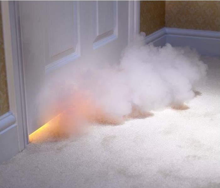 smoke entering room under door; blaze can be seen from bottom of door